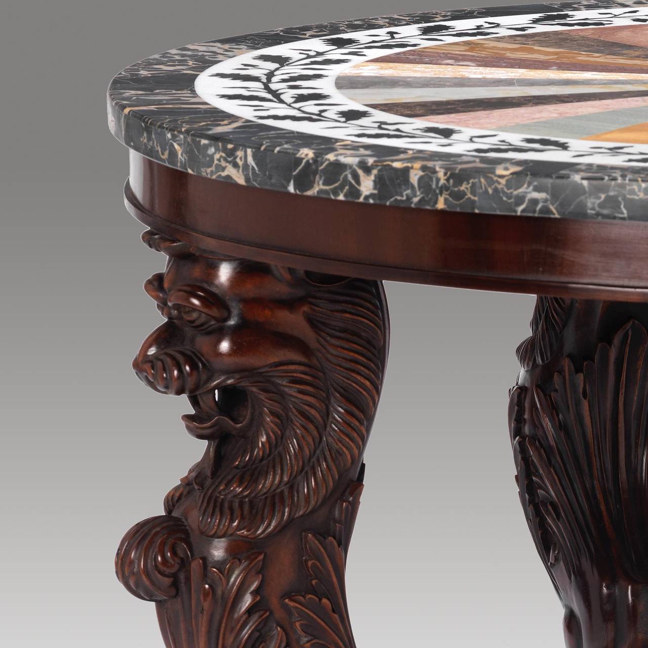 A fabulous quality Grand Tour inspired Regency design marble specimen topped carved mahogany centre table.

This table boasts the most fantastic color and patination complemented by an inlaid specimen marble top. The table takes its inspiration