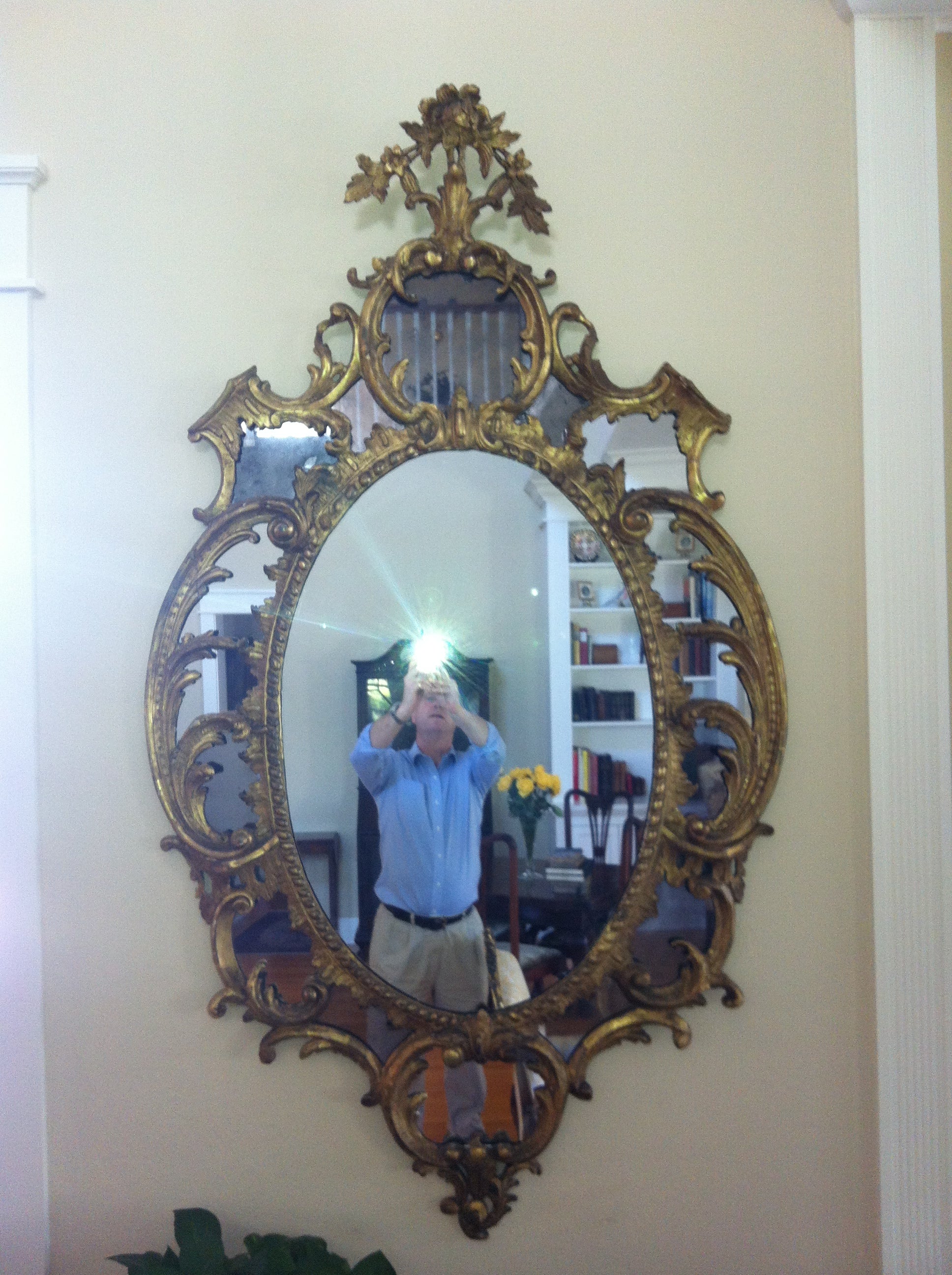 A fine pair of 18th c. giltwood oval mirrors in the manner of Chippendale For Sale