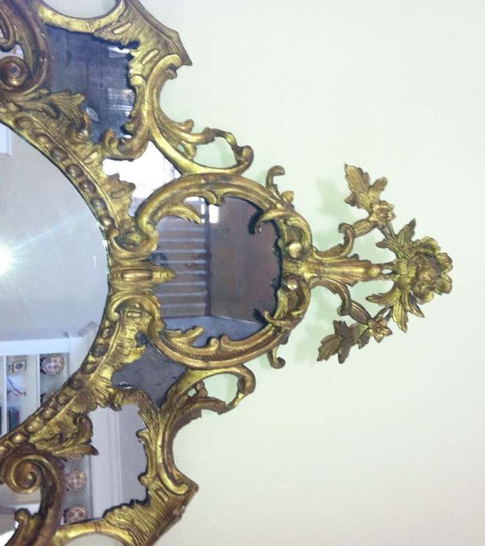 Rococo A fine pair of 18th c. giltwood oval mirrors in the manner of Chippendale For Sale