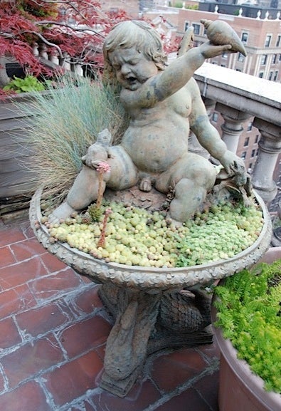 European A cast-iron fountain of a putto with spitting frog