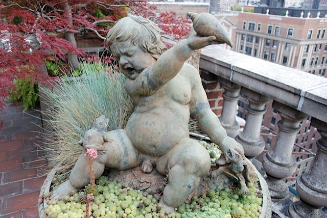 Iron A cast-iron fountain of a putto with spitting frog