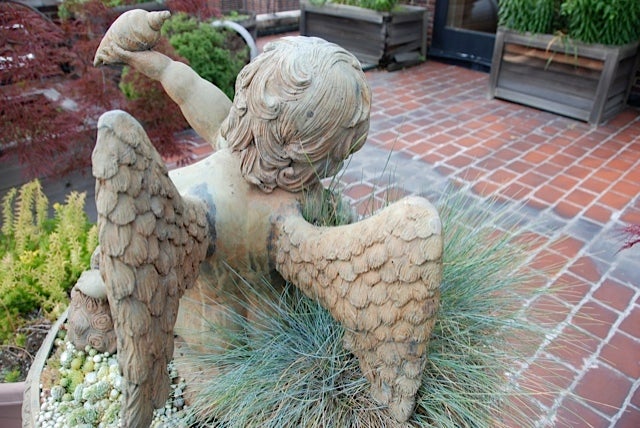 A cast-iron fountain of a putto with spitting frog 1