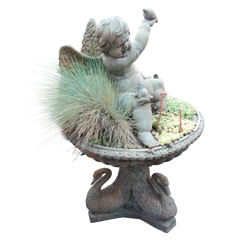 A cast-iron fountain of a putto with spitting frog