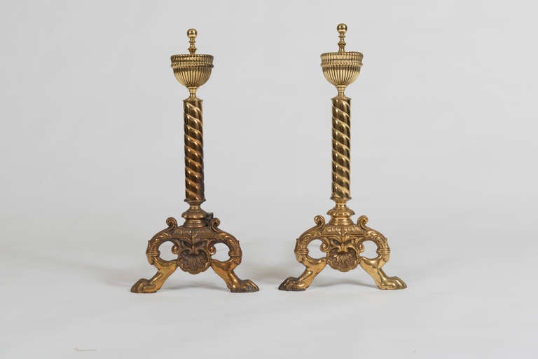 Each with spiral twist column surmounted by an urn and supported on paw feet.