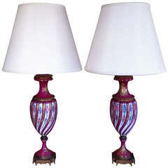 A pair of 19th Century Raspberry and Gilt Porcelain Vases Mounted as Lamps