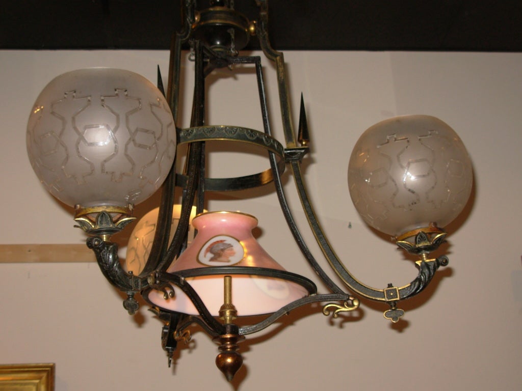 An important American Gasolier in the Egyptian Revival style, that has never been electrified, with original period acid etched globes, with a central Sandwich glass globe in the Egyptian taste, fixtures similar to this have been seen in American