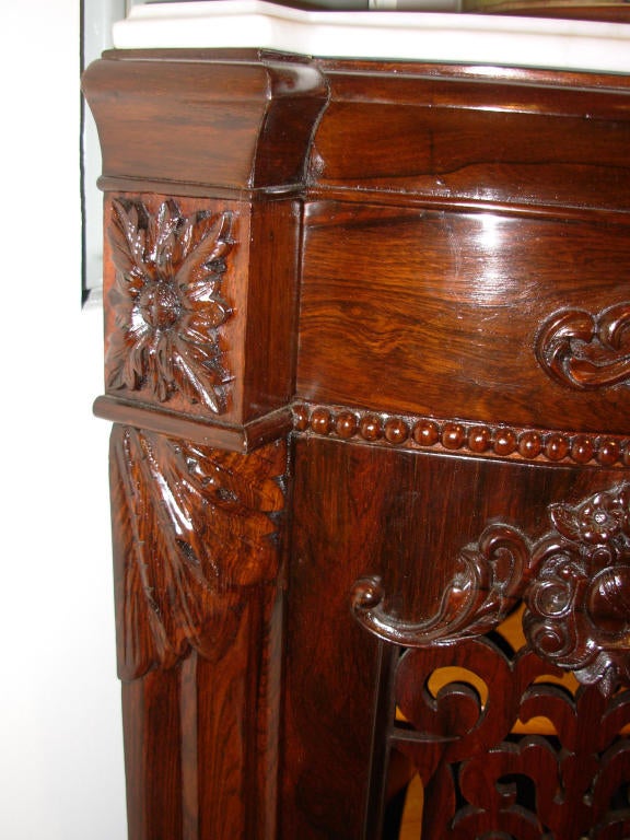 A labeled J & J W Meeks New York Rococo Revival rosewood corner cabinet with pierced fretwork on the door revealing a highly polished curly maple interior, raised on cabriole legs, with a beveled white marble top. The furniture of J &J Meeks