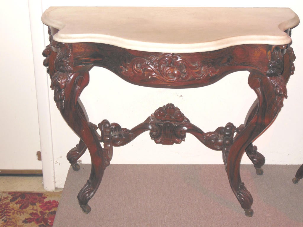 An American Rococo revival laminated rosewood console table by John Henry Belter, NY, circa 1850. Carved with fruits, leaves and c scrolls, table maintains original finish which has been polished over. The table is raised on four cabriole legs which