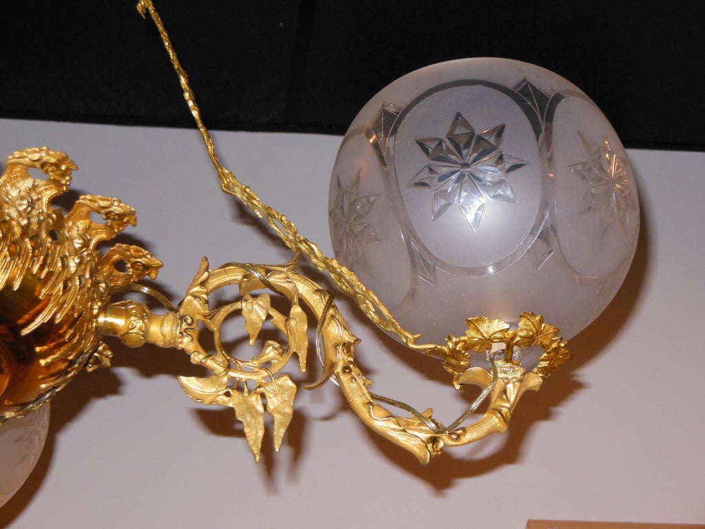 An American Rococo Revival gas chandelier, with four authentic period frosted and etched snowflake globes. The original chain links with cherubs. The chandelier is attributed to Cornelius and Company of Phila, mid-19th century. This is just one