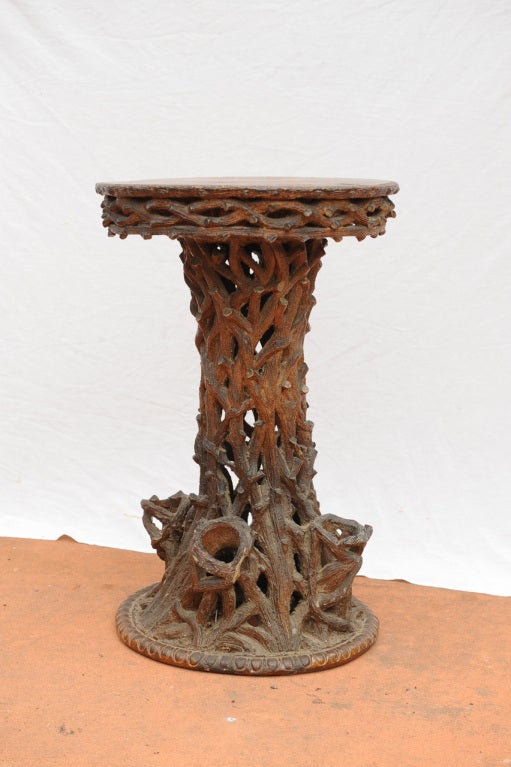 Rare and unusual sewer tile table with pierce carved column and three small pot holders on the base.