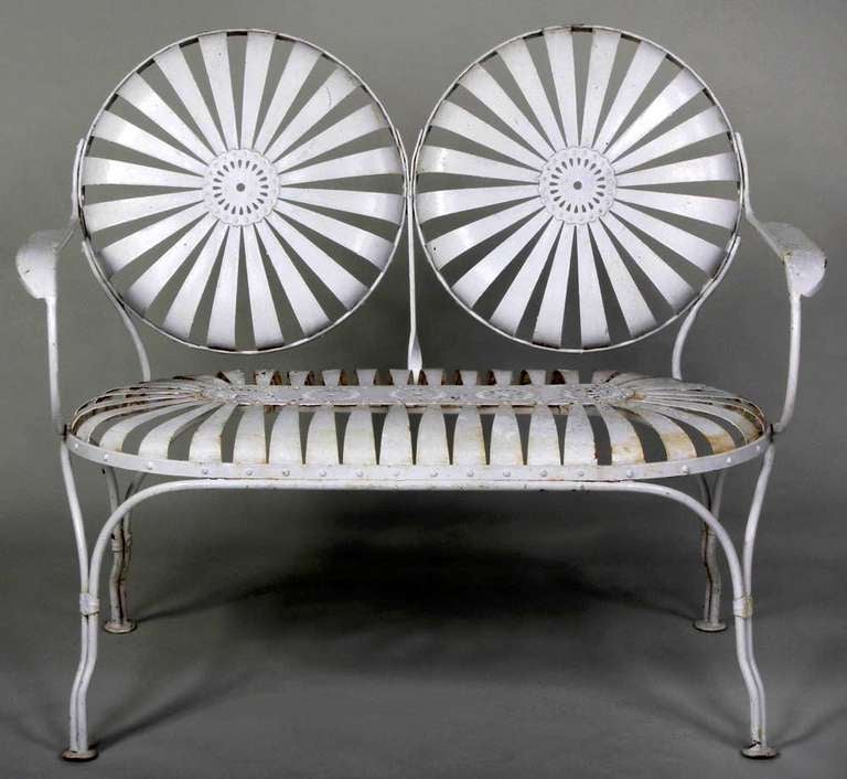 A wonderful spring form bench.or pinwheel bench,  this form was designed by Francois Carre circa 1930, found in old white paint, the two seater bench is a hard to find piece. This bench is shown as plate 394, in 