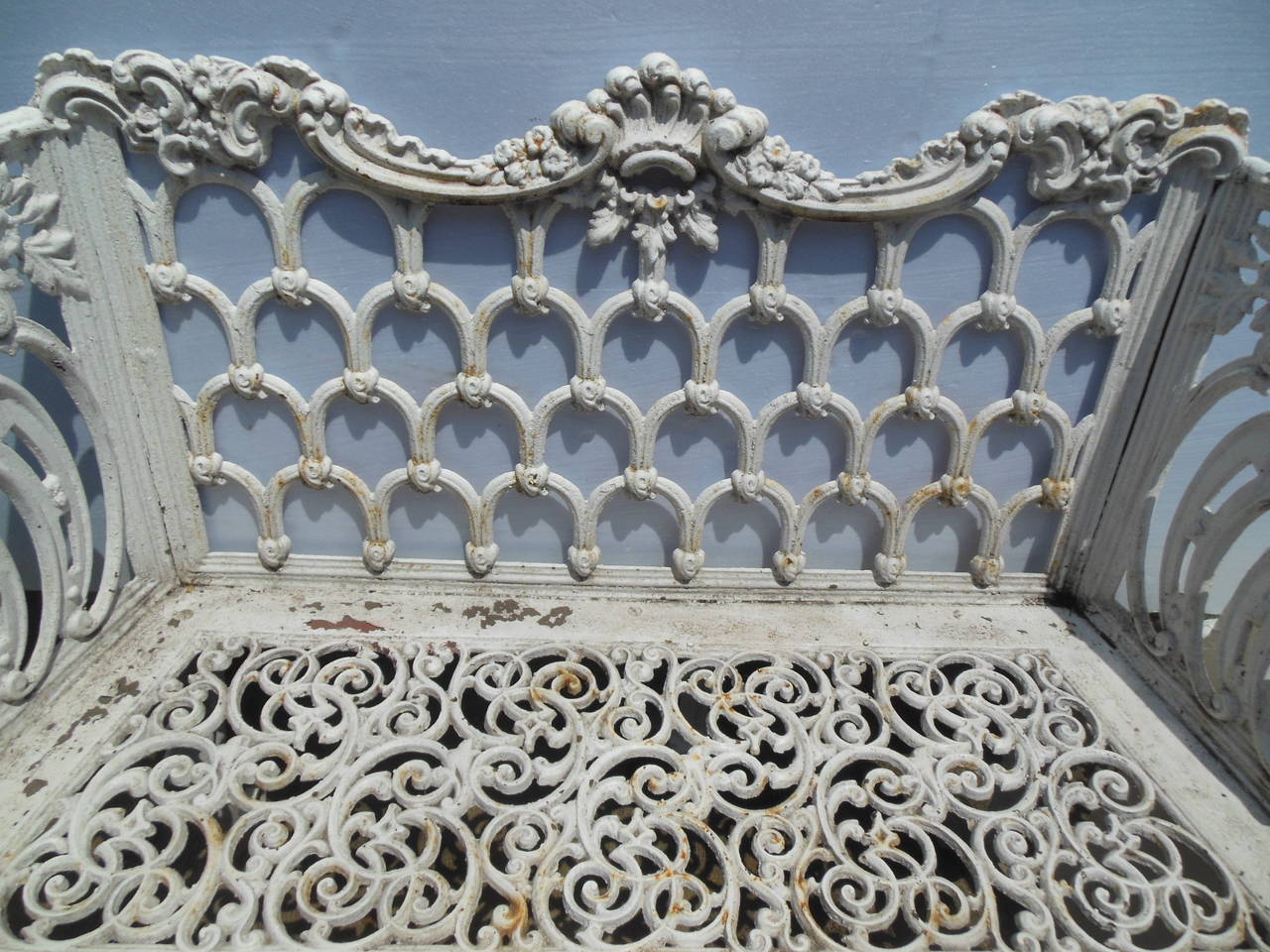 A late 19th century cast iron bench in the Gothic/Rococo Revival style.
This bench pattern became most popular when Jackie Kennedy bought one 
for the White House Rose Garden and has since then been called the White House Bench by many. It is in