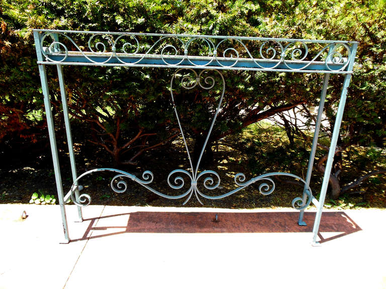 An American mid 20thC Wrought Iron Plant Stand, maintains original Blue Paint and is unusually tall being 45