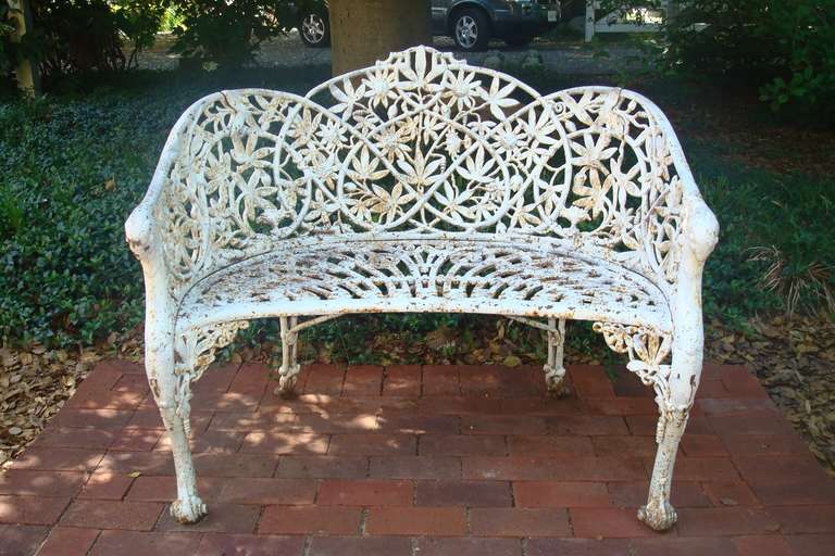 A Cast Iron Bench in the Elaborate Passion Flower Pattern. This pattern is rare and therefore not easily found. The detail of the flowers on this bench is crisp, and most naturalistic. The bench shows Rustification which of course could be covered