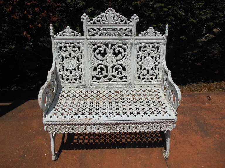 A fancy cast iron garden bench made in Brooklyn New York and patent dated 1895 by Peter Timmes Son. This filigree
patterned bench is the most elaborate of a school of benches made in New York City in the late 19thC and commonly referred to as the