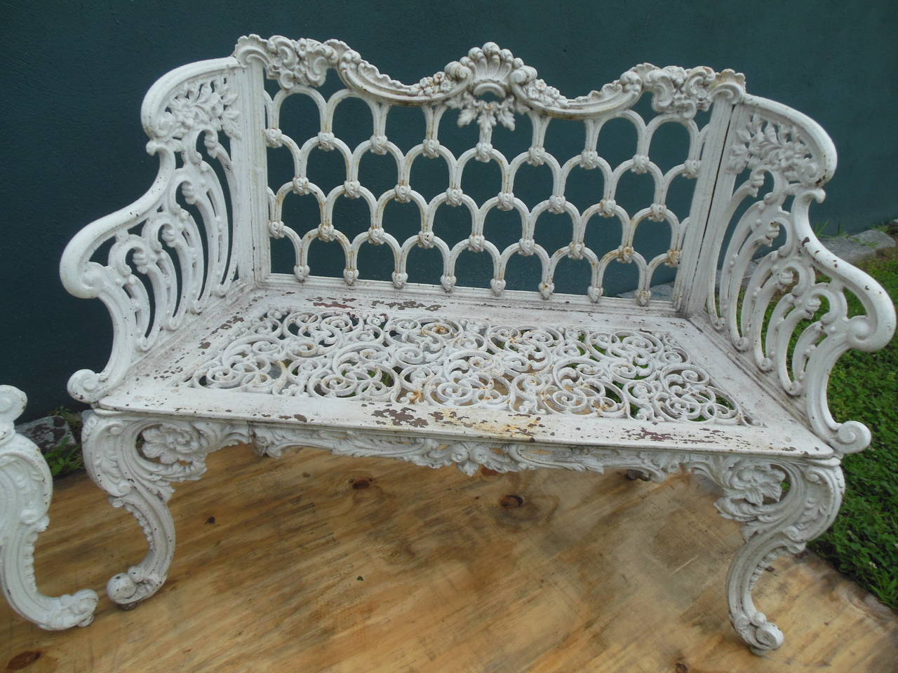 An assembled pair of late 19th century cast iron benches in the Gothic/Rococo Revival style. This pattern became most popular when Jackie Kennedy bought a Gothic Revival bench for the White House Rose Garden. Since then this pattern has been called