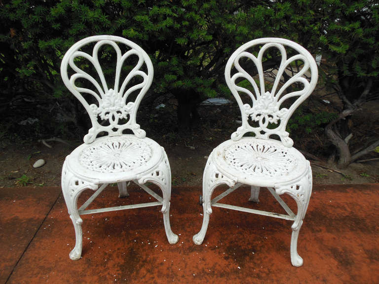 An interesting pair of 3 legged Victorian chairs,designed by Coalbrookdale in the third quarter of the 19thC. This form is so desirable that this chair appears on the cover of Cast-Iron Furniture by Georg Himmelheber. The chair has many layers of