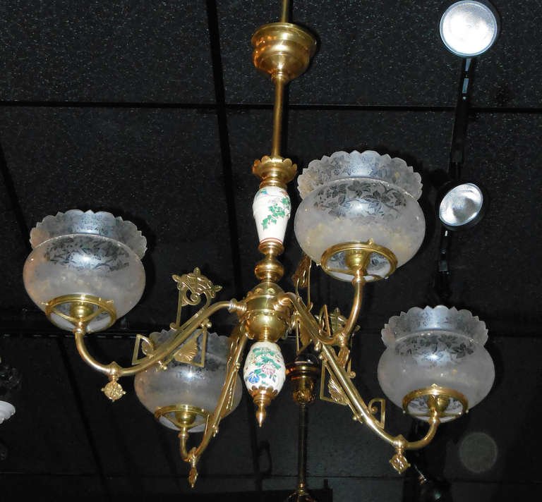 A four-arm brass Victorian gas chandelier with a Satsuma porcelain column, in the aesthetic style, the chandelier has just been restored and rewired. With desirable authentic period acid etched crown globes. Ask to see our chandelier video.