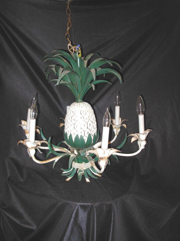 Six-arm shabby chic pineapple chandelier, maintains original paint, with minor rustification. The chandelier from the Hollywood Regency period. Also from the same era are a strawberry and a daffodil chandelier, along with many candle sconces.