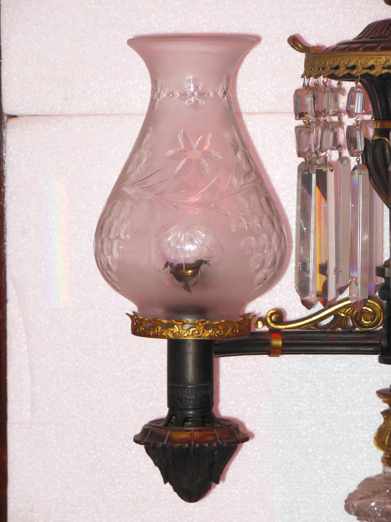 An Argand lamp, made in the first half of the 19th century and retailed by the prestigious company Baldwin Gardiner NY. This lamp maintains the original period frosted and cut globes, which are one of the best cut globes I have seen. The cut crystal