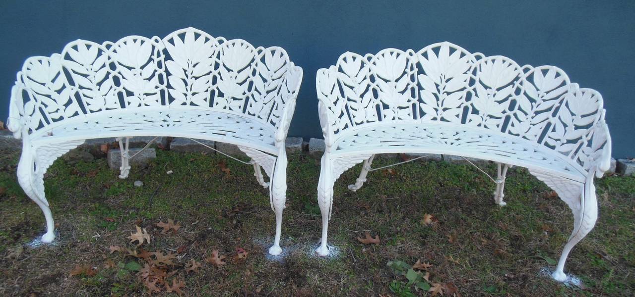 A cast iron bench in the Laurel pattern, with elaborate leaf detail. The benches are heavy and in excellent condition, with bird heads and legs with winged paw feet. This pattern is sometimes called Solomon's Seal. The benches are signed by the