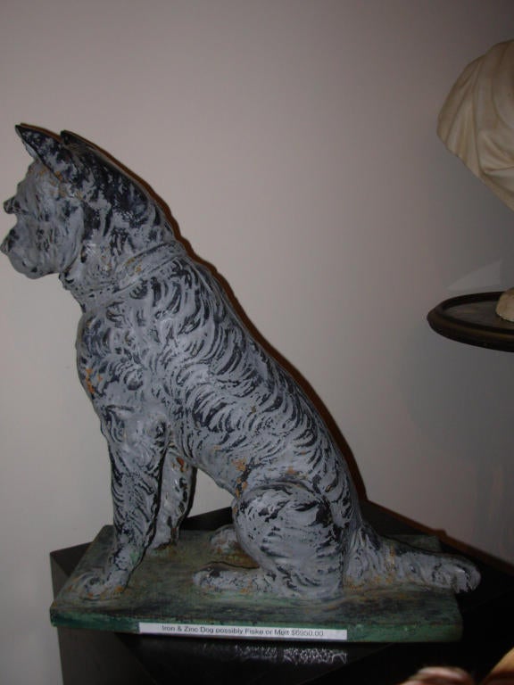 A Victorian cast iron and zinc dog maintaining the remainder of old gray paint, the dog was made in NY, circa 1870 and is attributed to either Fiske Or Mott, both well know cast iron foundaries in NY. Recently a virtually identical dog appeared on