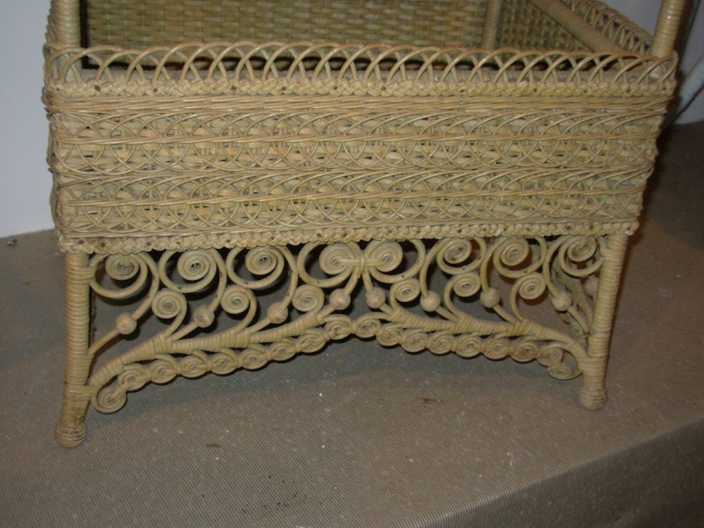 A natural wicker sewing basket, in an elaborate design, original and never painted.