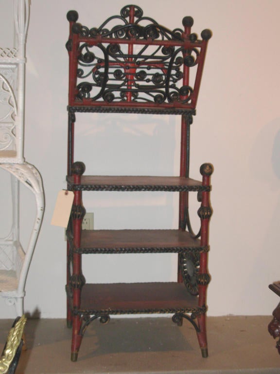 19th century wicker sheet music stand attributed to Heywood-Wakefield with an ornate and pierced folio on the top and shelves below, item still maintains its original painted surface, it is rare to find pieces in original painted surface.