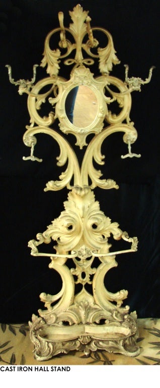 A late 19th century Rococo Revival hall Stand, with an original hanging mirror and umbrella Stand with original cast iron trays and hooks, with details of shells and leaves throughout. 