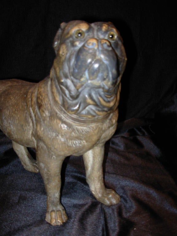 A terra cotta standing Pug dog with glass eyes, from a collection of terra cotta 
Pug dogs.