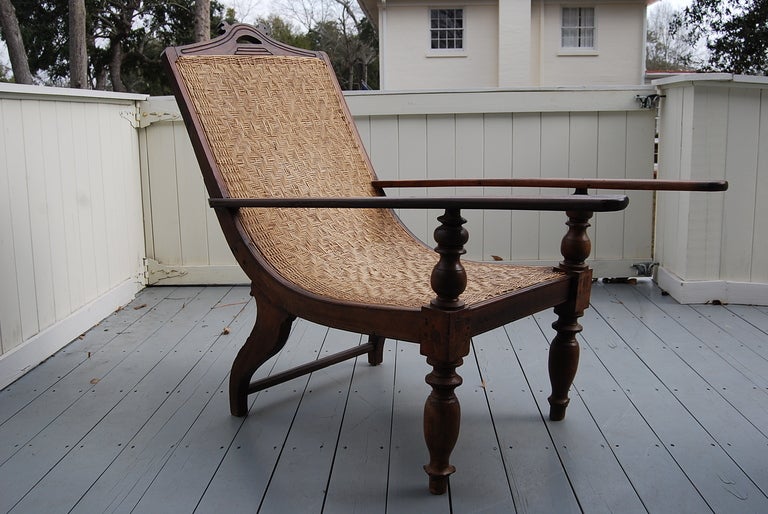 Lovely British Colonial Planter's/Plantation Chair.  Simple carved details on legs and rails. Seat looks to have been caned within the last 20 years.
