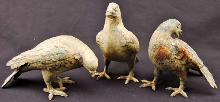 Set of three cast-iron pigeons.