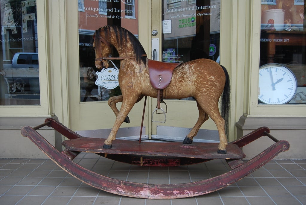Amazing oversized victorian rocking horse.  Covered in hide and glass eyes.