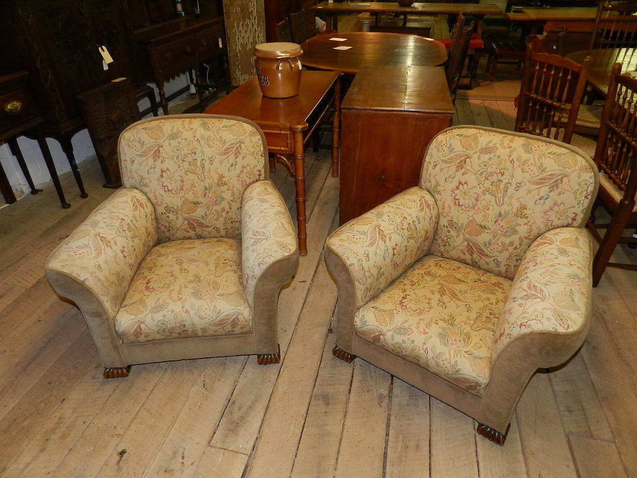 Pair of upholstered armchairs with original covers and carved oak feet.