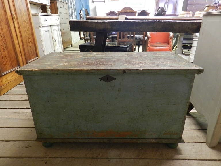 Antique pine trunk with original torquoise paint and bun feet.