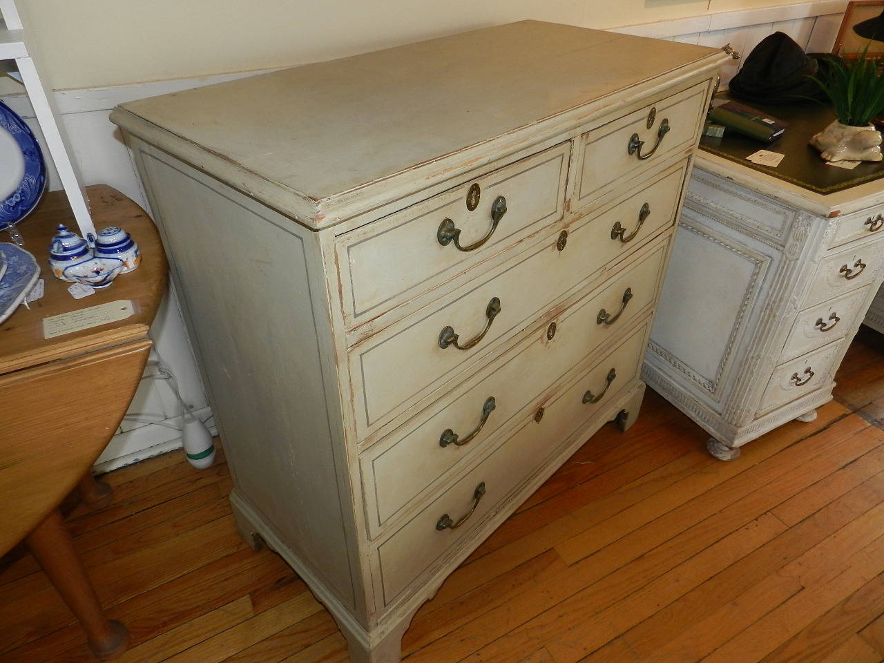 Antique pine chest of drawers with antique brass handles and bracket feet. The paint finish has been restored.