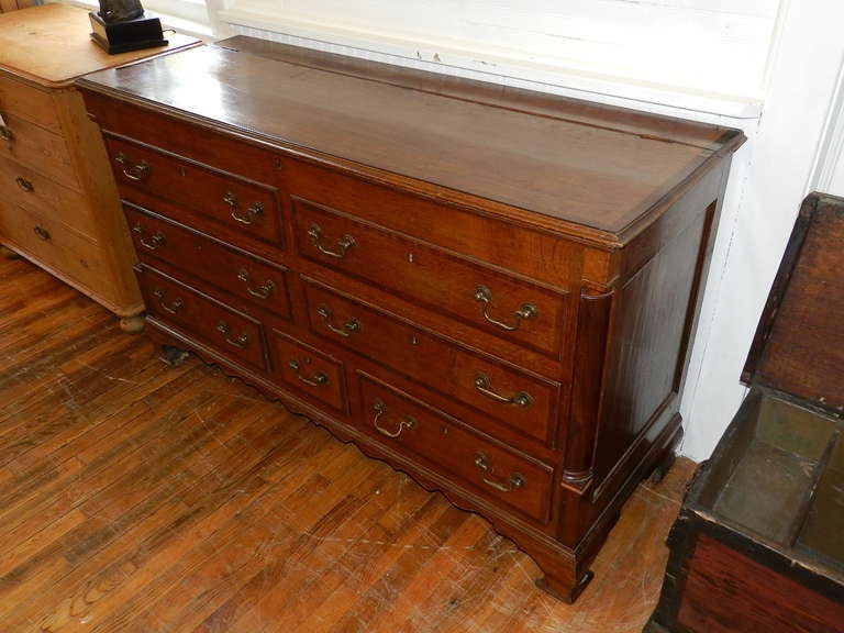 Scottish Oak Mule Chest with mahogany cross banded drawer fronts , twin turned quarter columns, panelled ends and original brass swan neck handles. This piece is supported upon original French style shaped bracket feet and shaped apron. The upper
