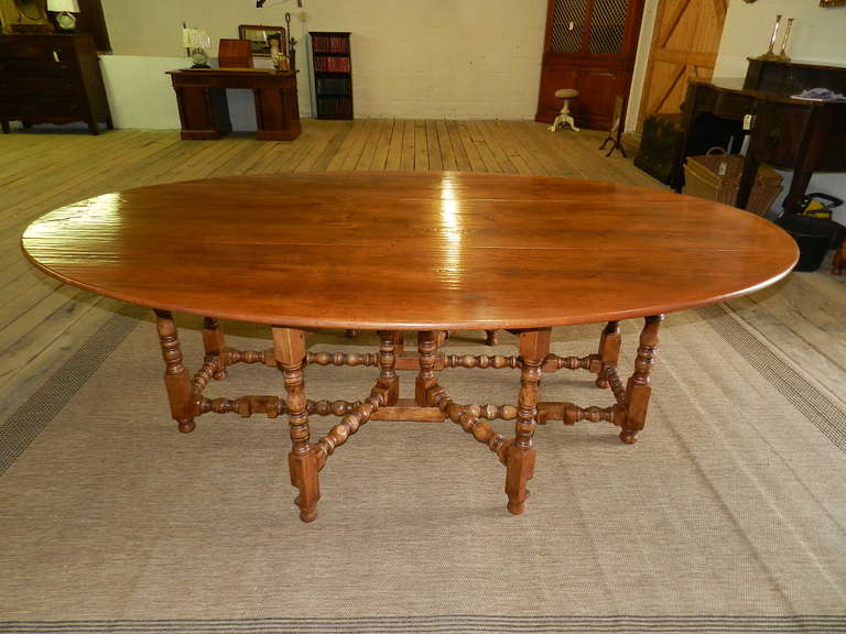 Solid cherry bobbin turned double gate-leg dining table.All joints are pinned and the bobbin turnings are hand done. The drop leaves can be lowered to form a very useful server or sofa table