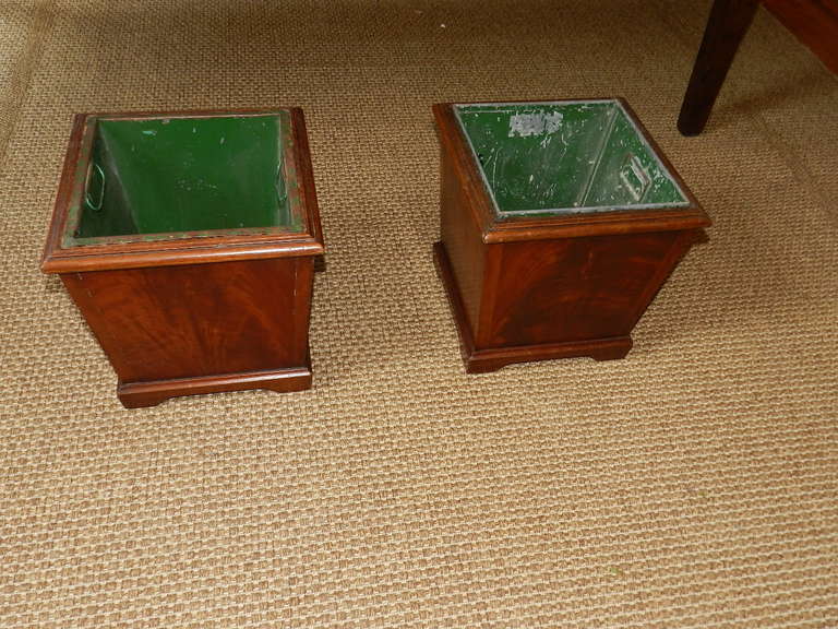 A pair of mahogany planters with original metal liners.