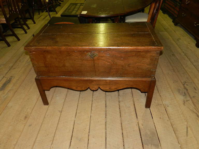 Elm trunk on stand with dovetailed joints.The iron handles,lock  and hinges are original. The  interior also has the original candle box.