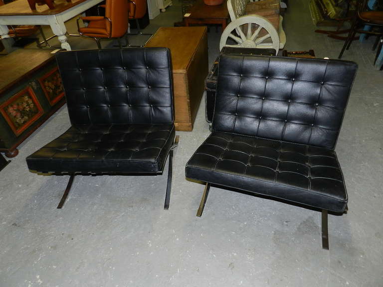 Pair of chrome framed Barcelona style chairs with buttoned vinyl seats.