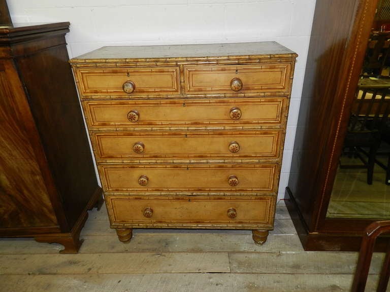 This is an early Scottish chest with all original faux bamboo paintwork and moldings.  Having two drawers over four longer drawers, the chest offers great storage.  The piece has similarly original painted sides and surface and rests on tall bun