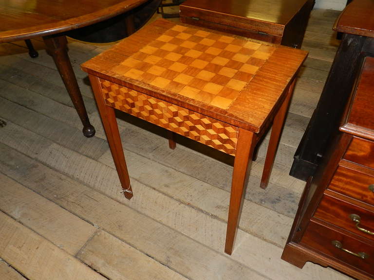 Mahogany game table with parquetry decorated sides and straight tapering legs