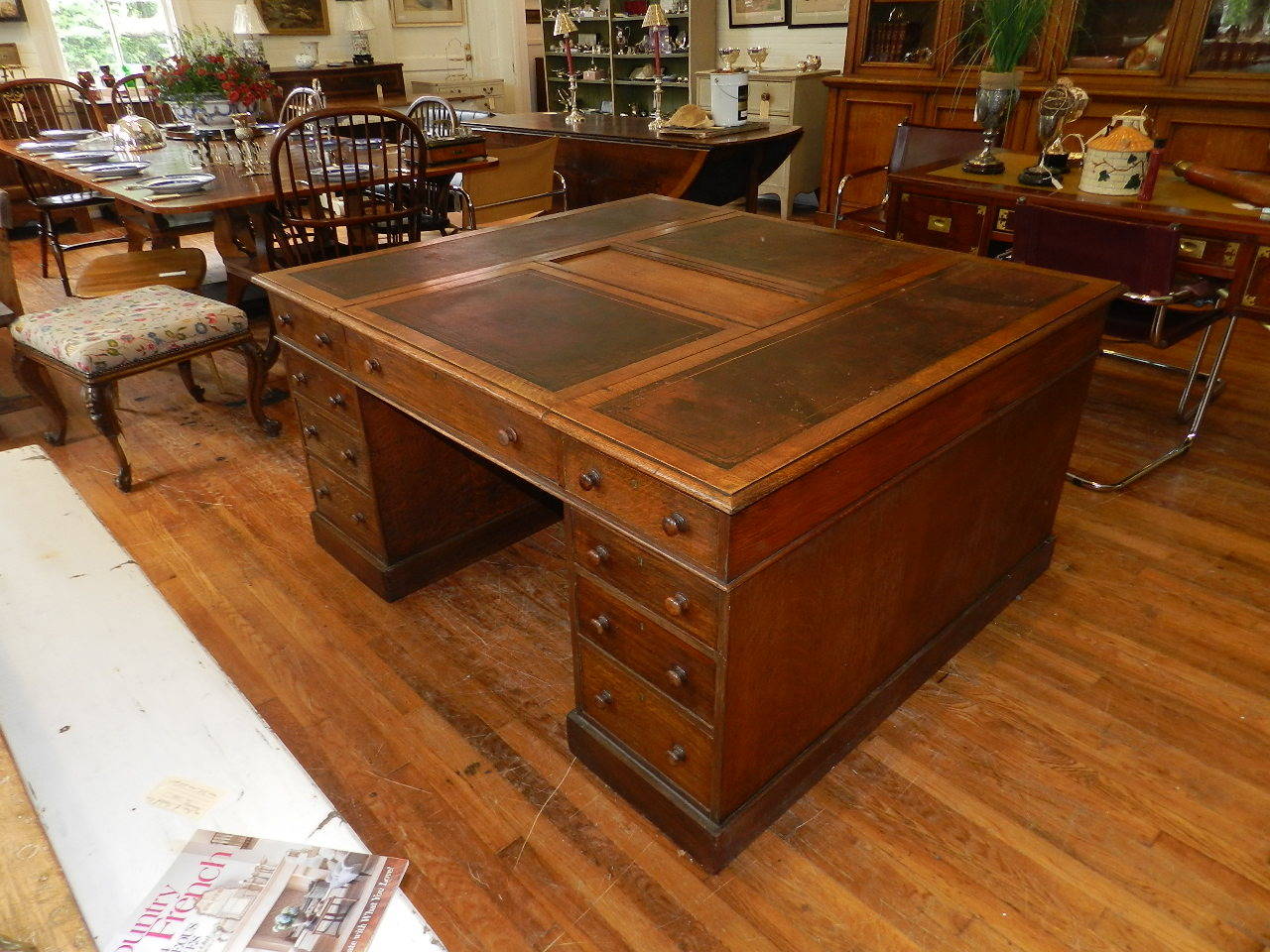 Oak twin pedestal partners desk with original  tooled leather top. All drawers are dovetailed and have the original knobs. The upper section has a pair of lidded compartments.The original leather top has some wear and patina which enhance the