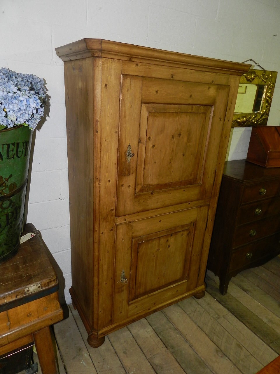 Antique pine cupboard with twin raised panel doors enclosing a pair of separate cupboards.