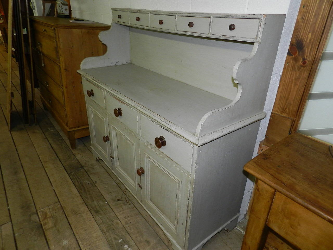 Scottish antique pine server with grey paint finish. Upper section has five small dovetailed drawers. The lower section has three dovetailed drawers over three paneled doors. All the drawers have mahogany wooden knobs.