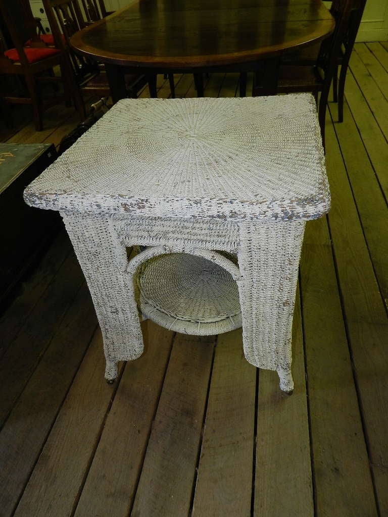 Antique wicker side table with nicely worn white paint
