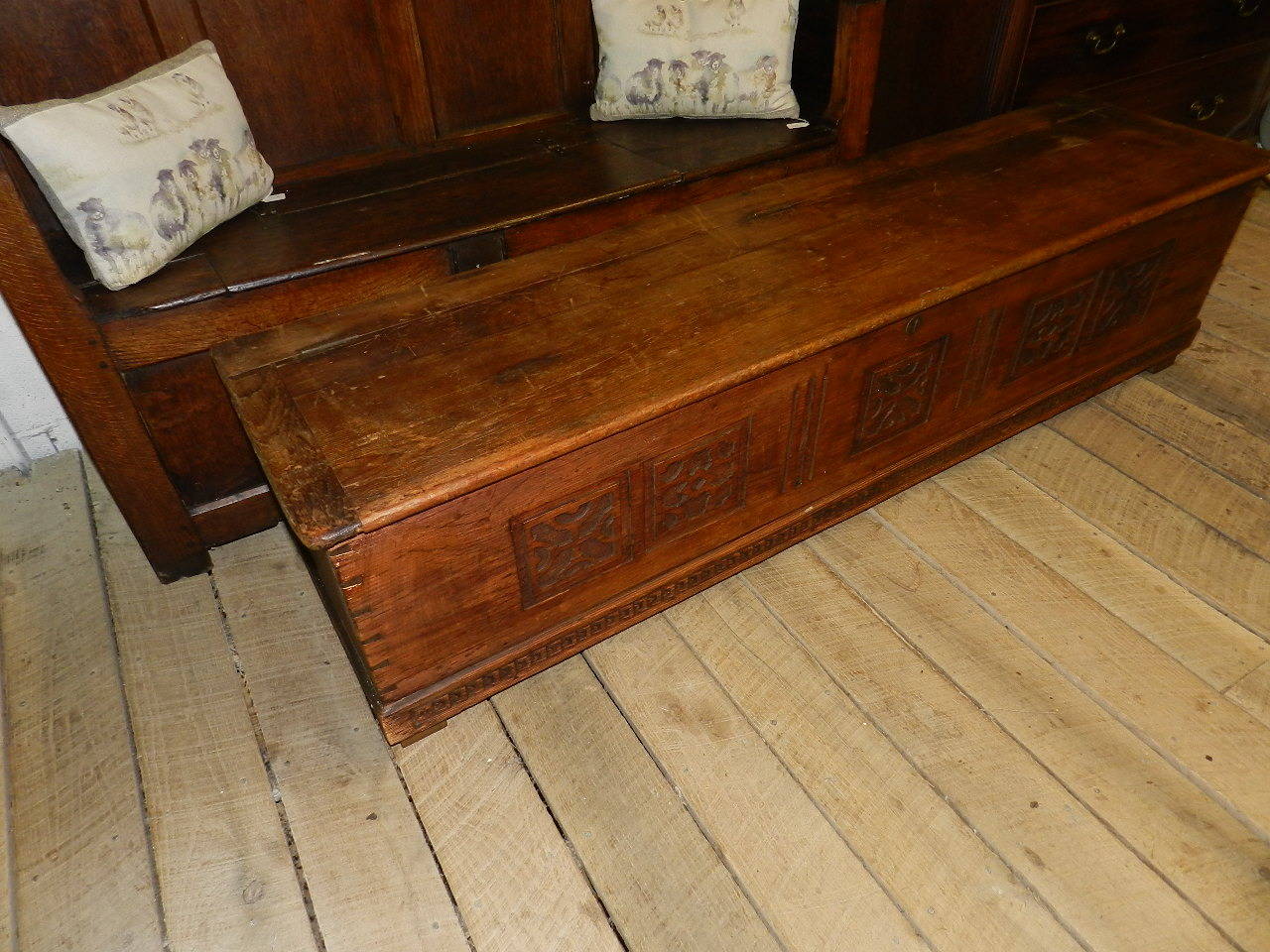 Antique pine coffer with carved detail and dovetailed joints.