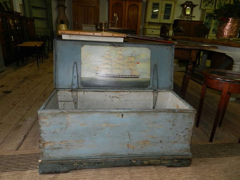 Antique pine ship's chest with original hinges and rope handles . Finish is original blue paint. The inside opens to reveal a well painted sailing ship in oil paint.