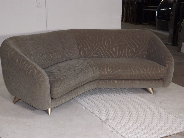 A spectacular custom sofa made by Weiman. Upholstered in a beautiful, soft custom fabric. Silver leafed legs complete the design. Gorgeous.